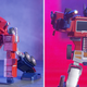 The Robosen Elite Edition Auto-Converting Optimus Prime striking two familiar heroic poses.